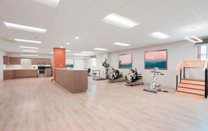 A spacious and minimalist gym with exercise equipment set up for workouts.