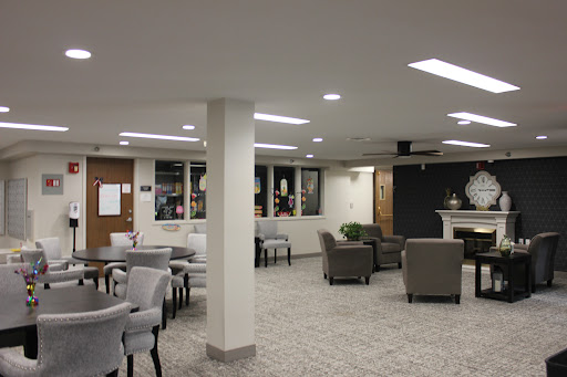 A spacious and modern lounge area featuring comfortable seating and ambient lighting.