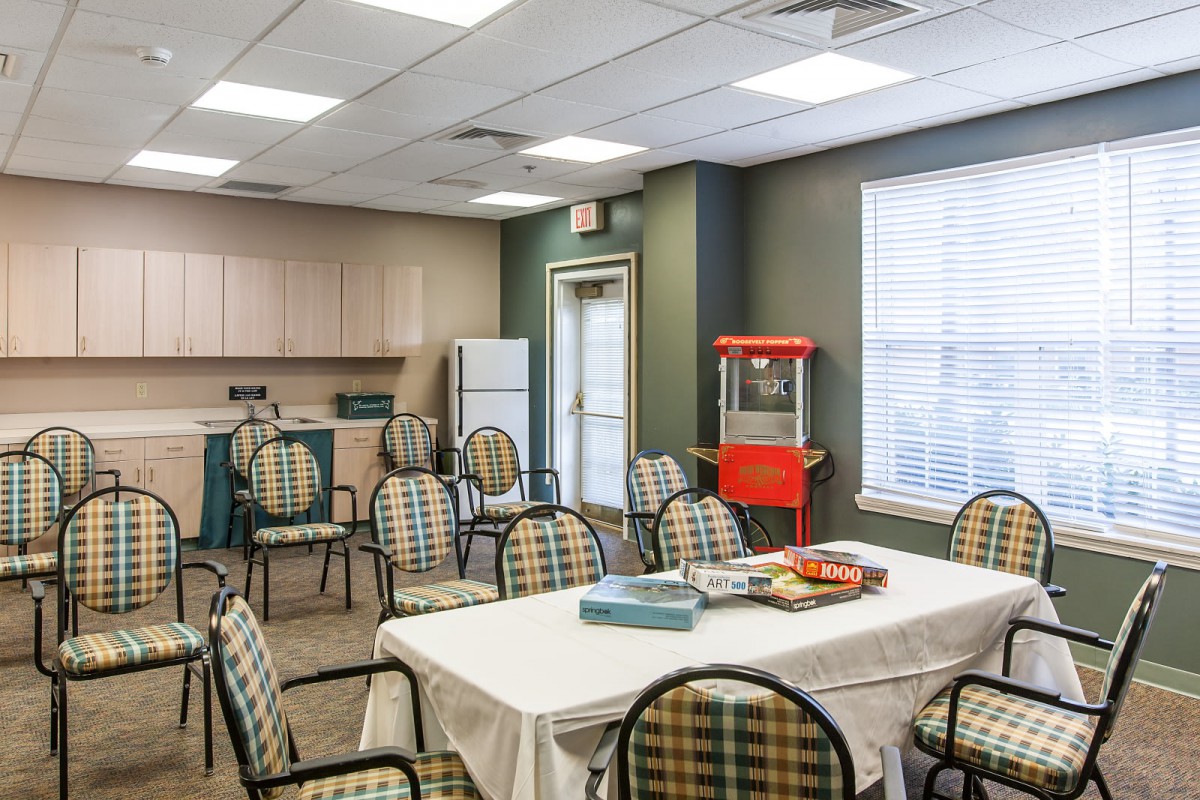 A small meeting room with a kitchenette and a popcorn machine.