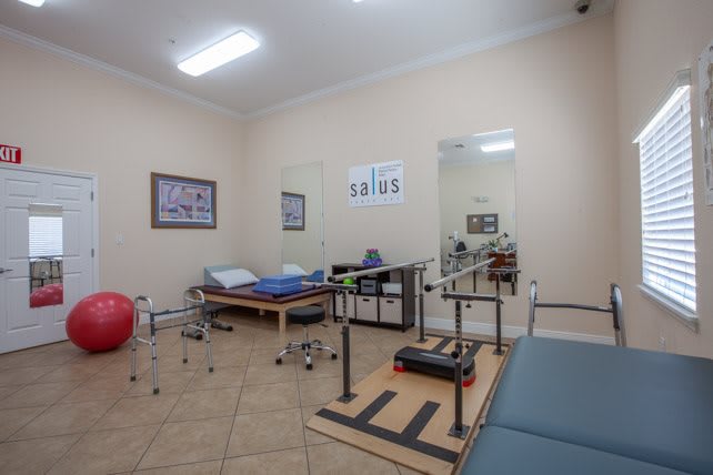 A physical therapy clinic equipped with exercise tables and rehabilitation equipment.