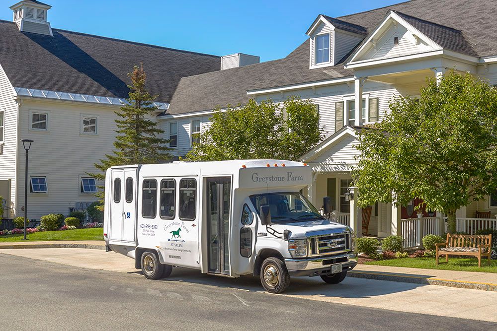 A shuttle bus parked in a suburban residential area.