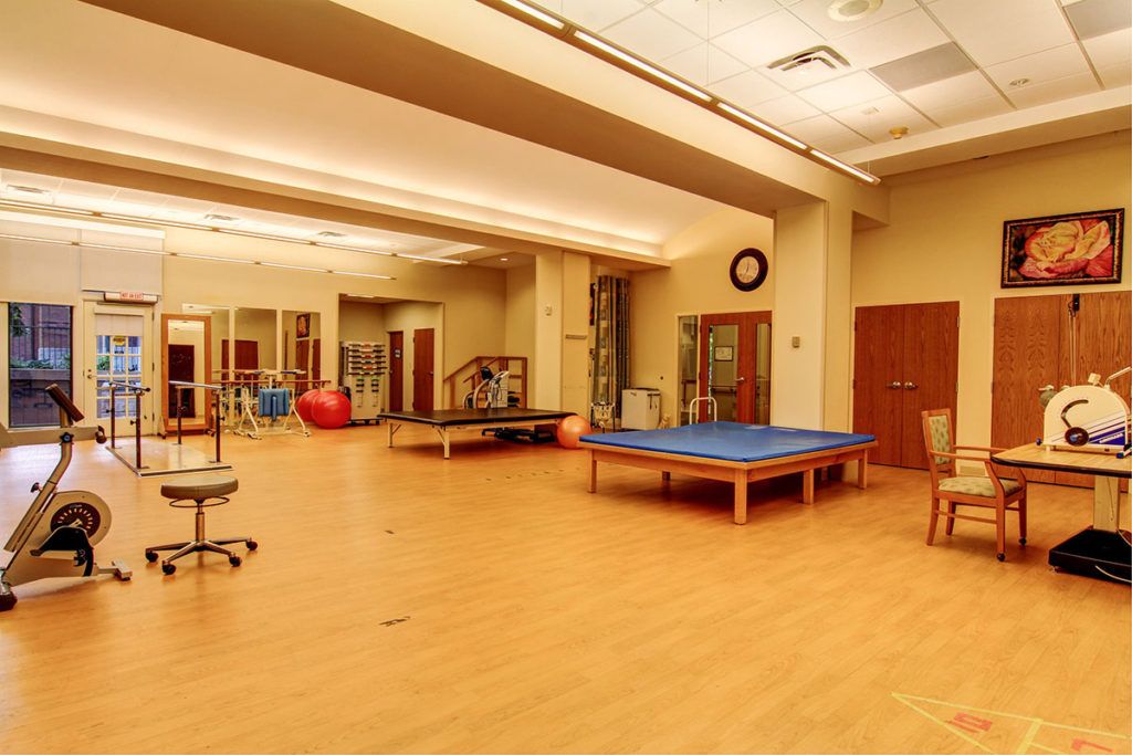 A spacious rehabilitation room equipped for physical therapy and wellness exercises.