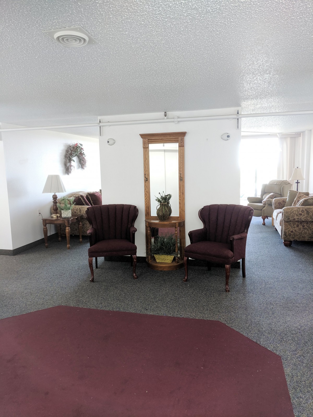 A cozy living room with vintage furniture and decorative elements.