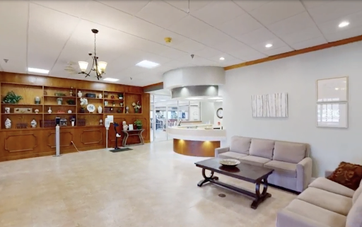 A modern and inviting waiting room featuring comfortable seating and elegant wooden accents.