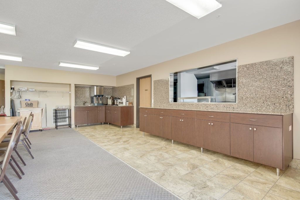 A spacious, modern kitchen with ample cabinetry and sleek lighting.