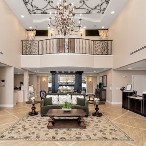 A grand, luxurious lobby featuring a chandelier and elegant furnishings.