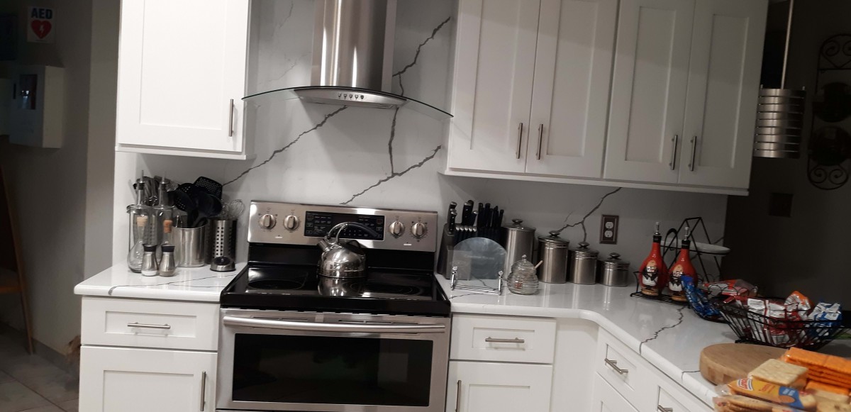 Modern kitchen with sleek cabinets and a stainless steel stove.