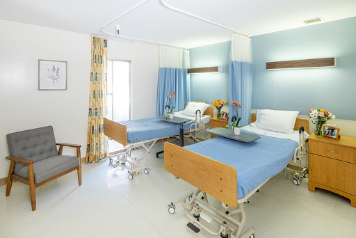 A bright and clean hospital patient room with two beds.