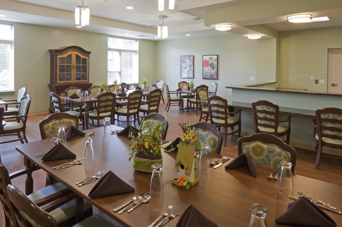 A well-decorated dining area with neatly arranged tables and chairs.
