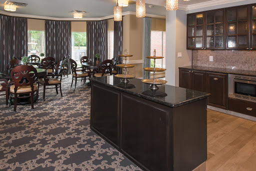 A modern and inviting dining area featuring elegant furniture and a kitchenette.