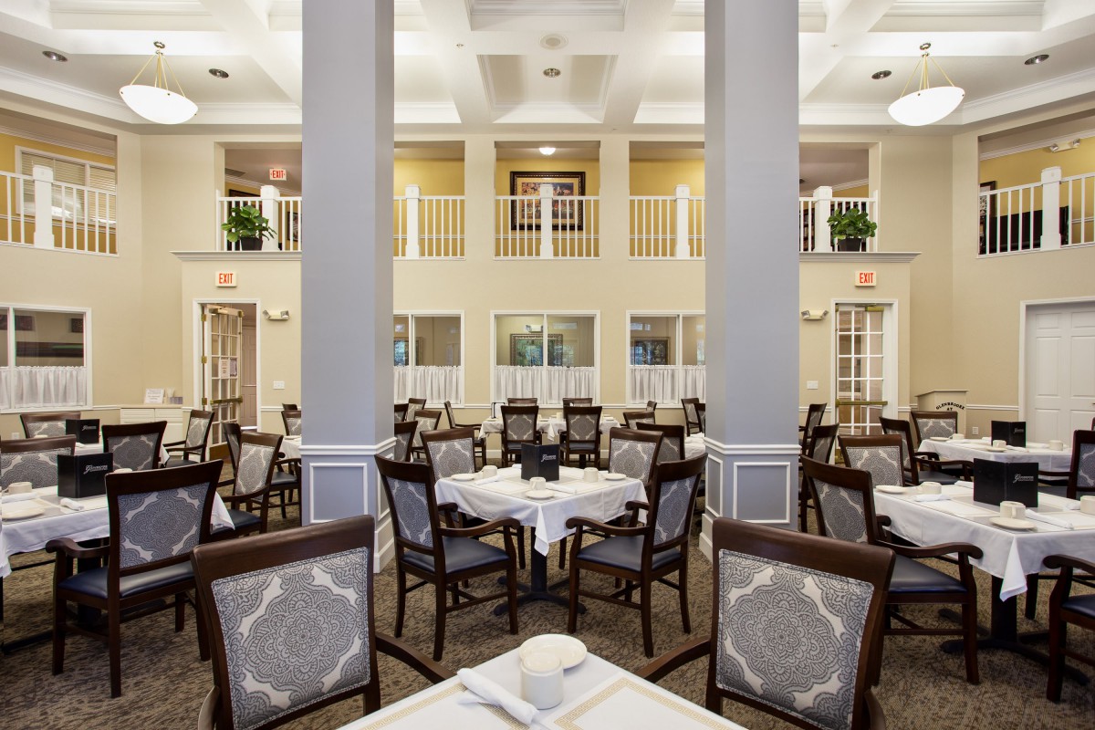 An elegant dining area with neatly arranged tables and chairs in a formal setting.