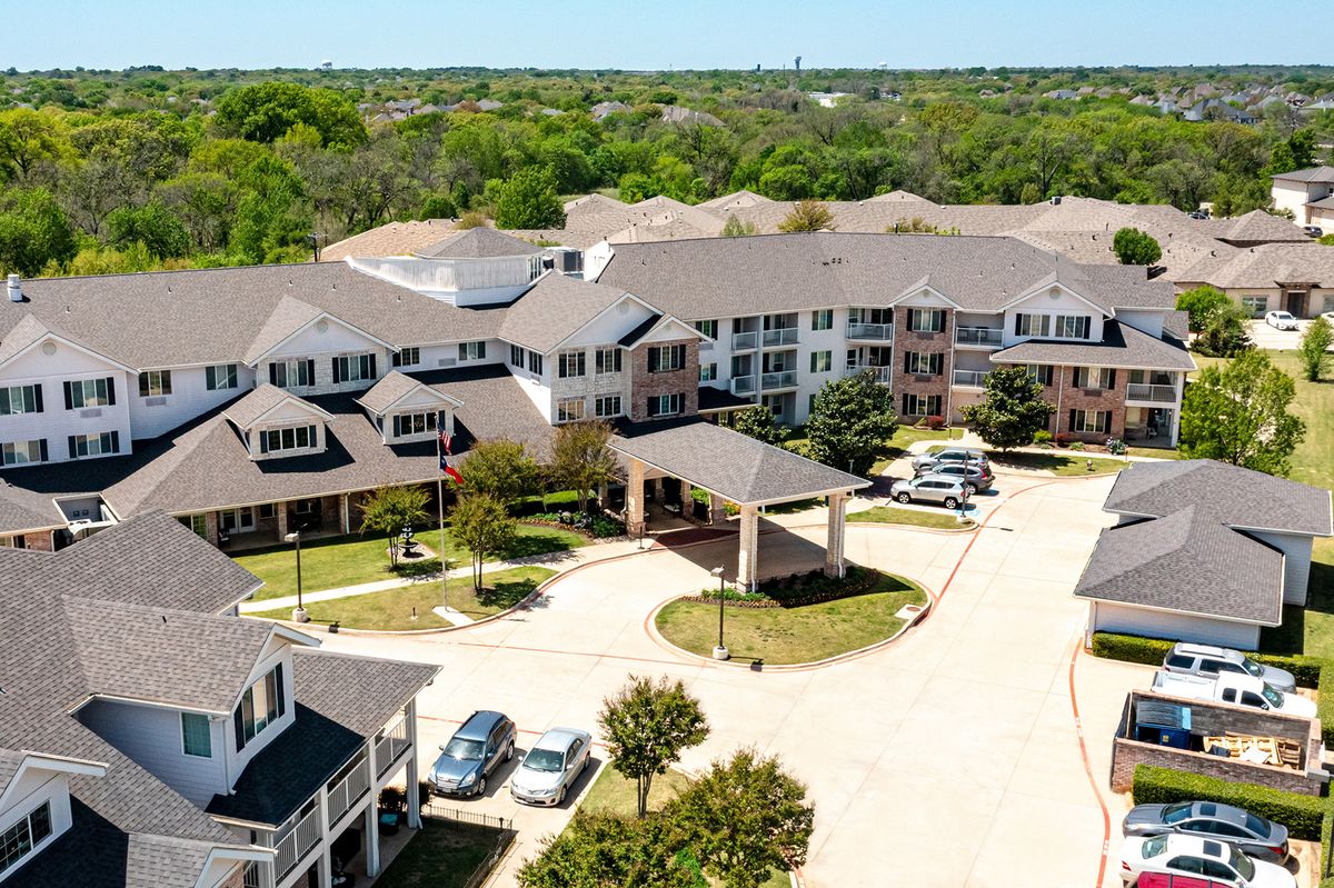 Aerial view of a suburban residential housing complex surrounded by greenery.