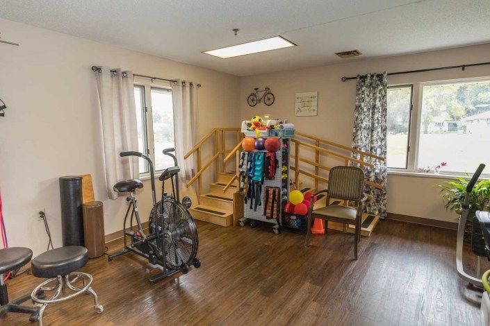 A therapy room equipped with exercise equipment and training tools.