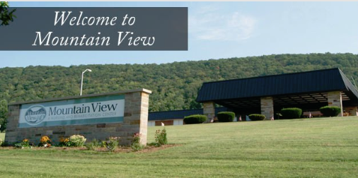A welcoming view of the Mountain View sign amidst a lush landscape.