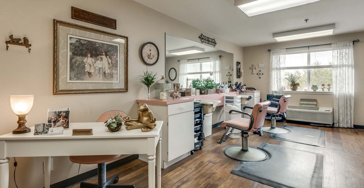 A cozy salon interior with styling chairs, mirrors, and decorative elements.