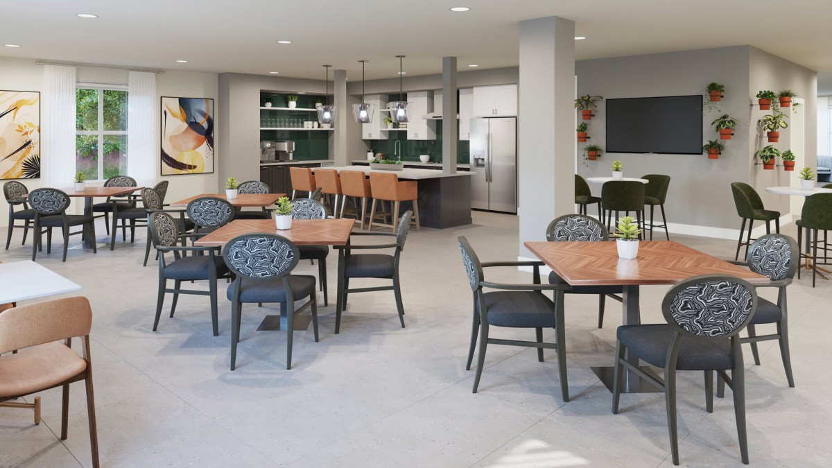 A modern dining area with seating arrangements and a kitchen in the background.
