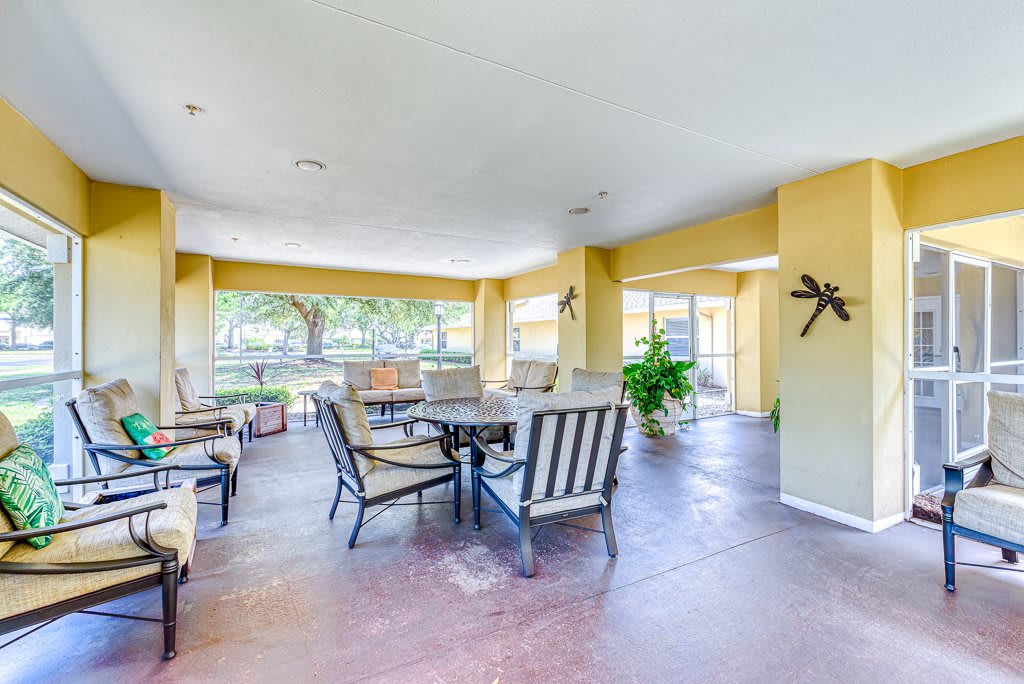 A bright and spacious outdoor patio area with seating and tables.
