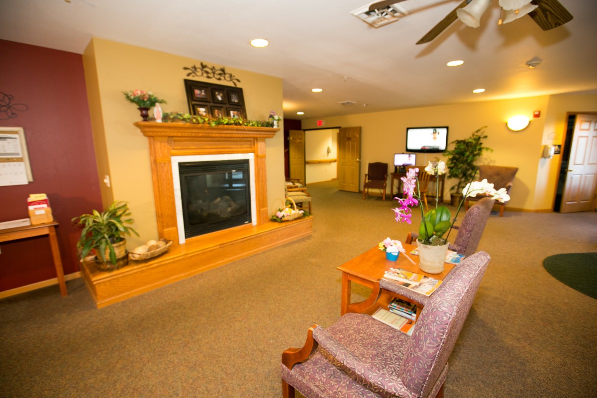 A cozy living room with a fireplace and comfortable seating.