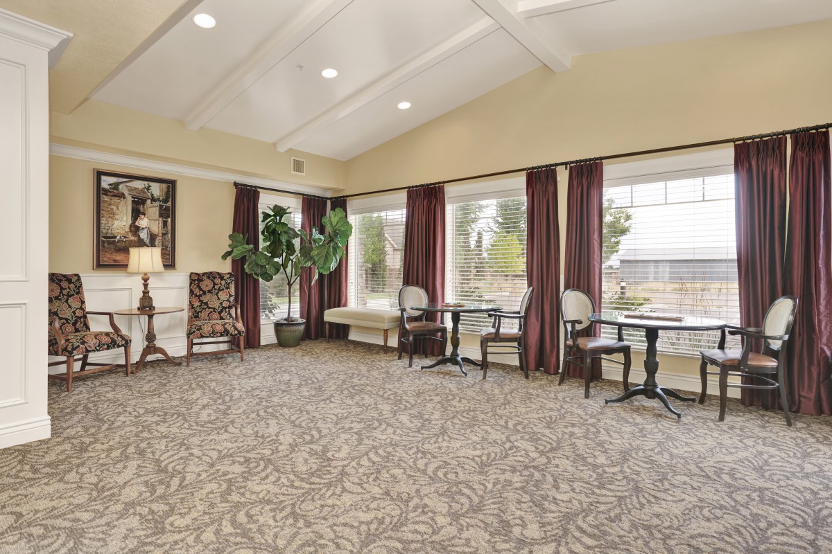 A cozy, well-lit living room with elegant furniture and large windows.