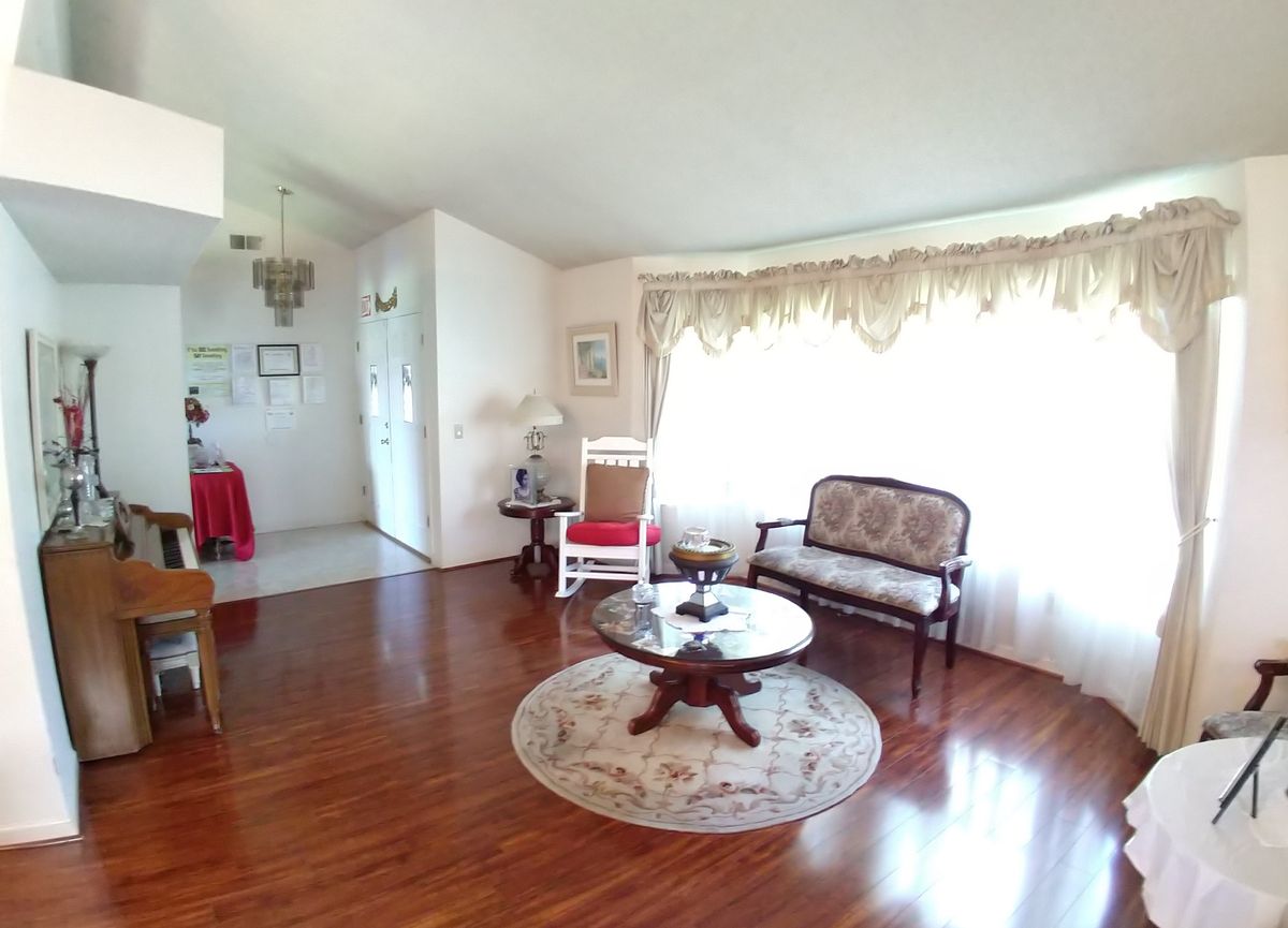 A cozy living room with elegant furniture and a hardwood floor.