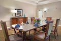 A well-furnished dining room with a table set for a meal.