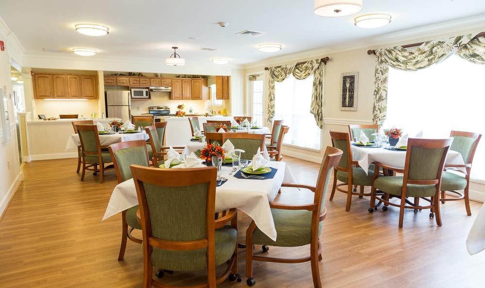 A cozy dining area with neatly arranged tables and chairs, featuring a warm and inviting decor.