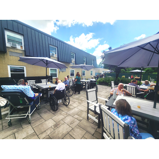A lively outdoor cafe scene with people enjoying the sunny weather.