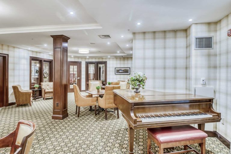 A cozy lounge area featuring a piano and comfortable seating arrangements.