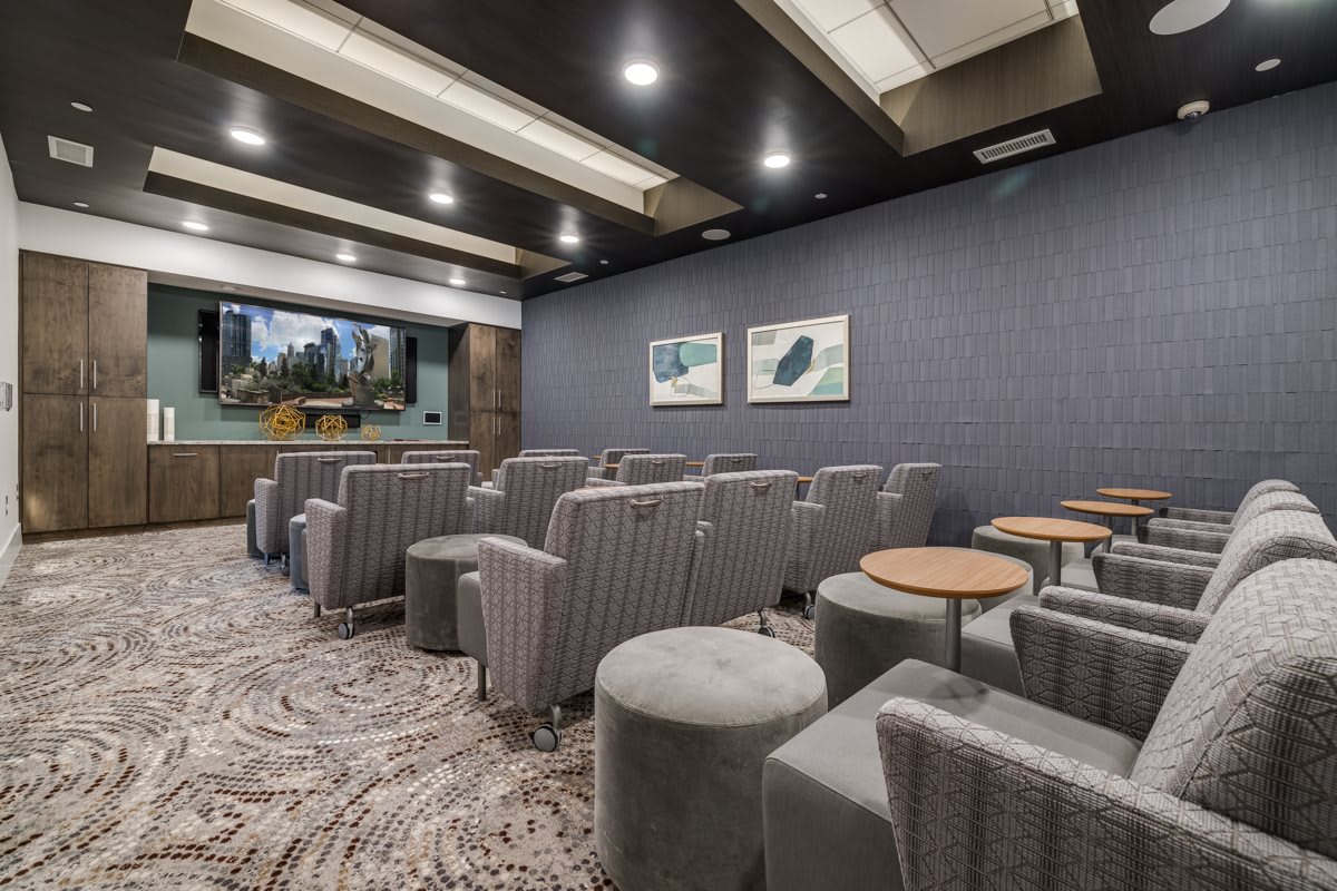 A luxurious home theater with comfortable seating and a large screen.