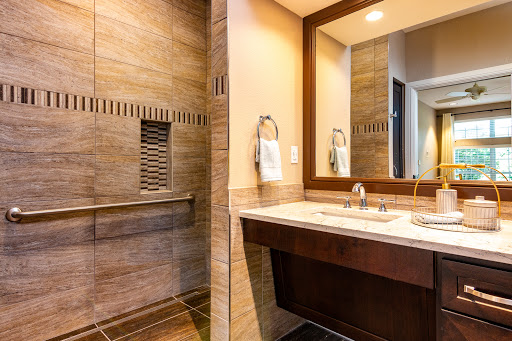 A modern bathroom featuring a spacious shower, elegant sink, and stylish mirror.