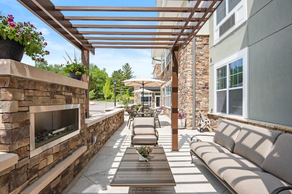 A modern patio with a pergola and comfortable outdoor seating.