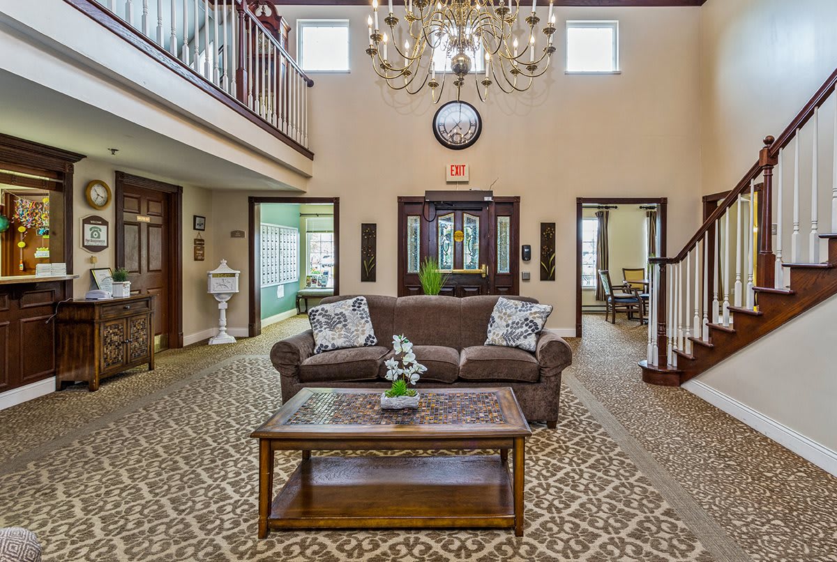 Elegant living room with a chandelier, sofa, and coffee table.