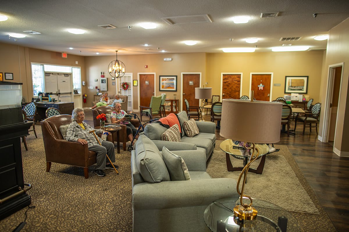 A cozy common area in a nursing home, furnished with comfortable seating and accommodating seniors.