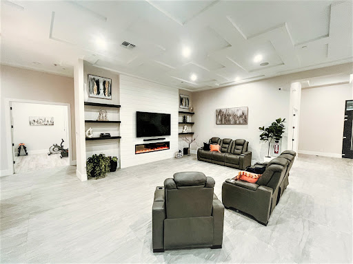 A modern living room featuring comfortable seating and a sleek entertainment setup.