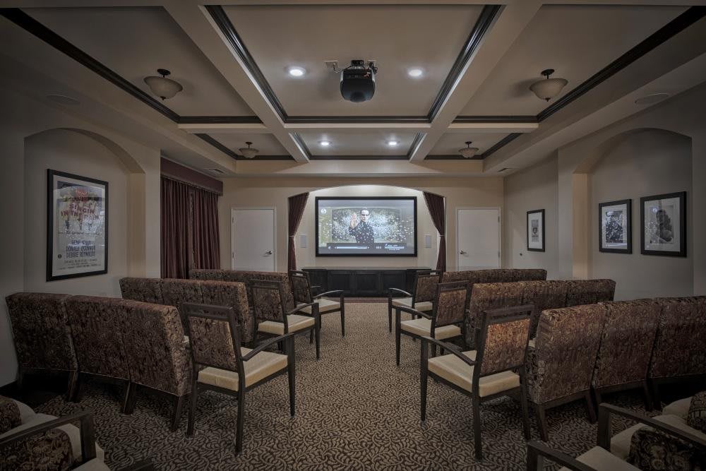 A spacious home theater with comfortable seating and a large projector screen.