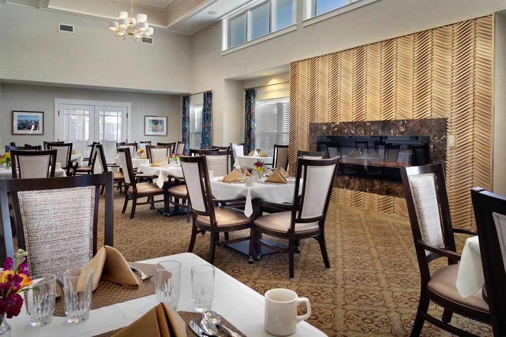 An elegant dining room with neatly arranged tables and chairs in a formal setting.