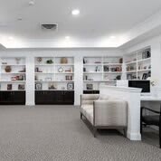 A modern library interior with bookshelves and seating.