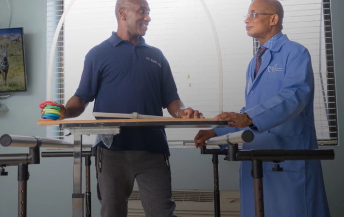 Two individuals engaged in a discussion at a workplace.