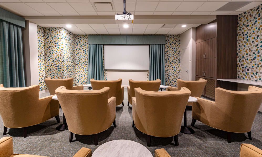 A cozy home theater with comfortable seating and a large screen.