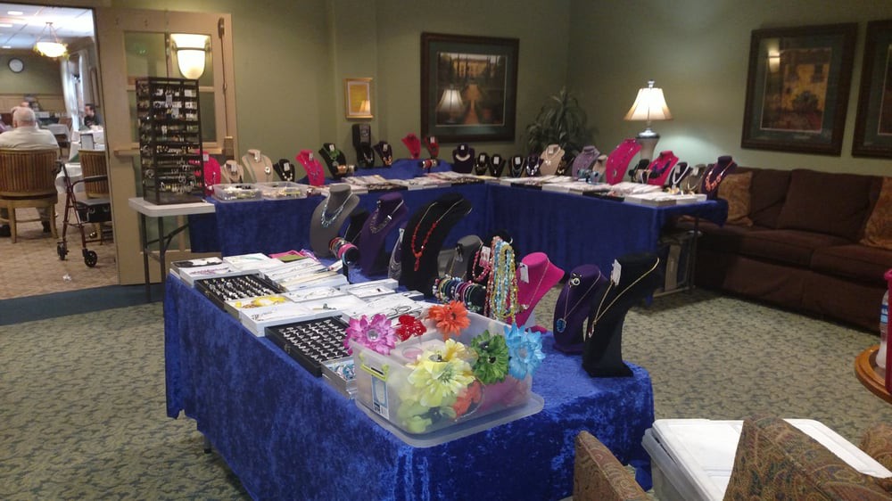 A room with tables displaying various pieces of jewelry and accessories.