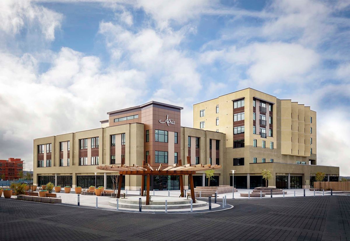 A modern hotel building with contemporary architectural features under a cloudy sky.