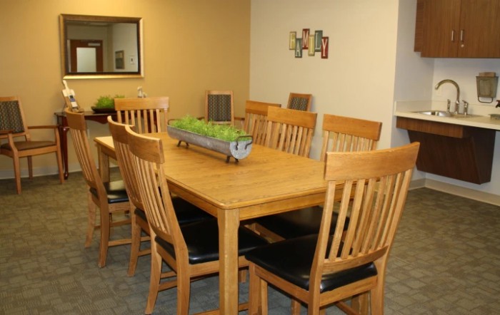 A cozy dining room with a wooden table and chairs, adorned with a decorative centerpiece.