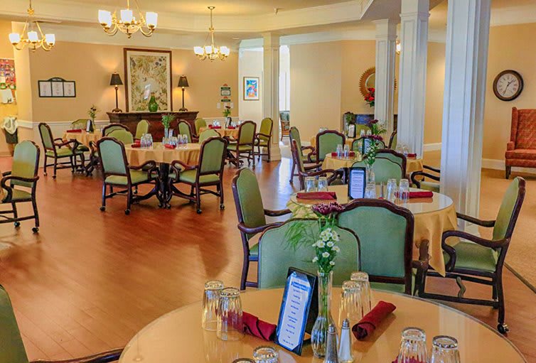 An elegant dining room with neatly arranged tables and chairs, creating a welcoming atmosphere.