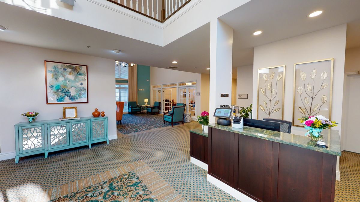 Modern lobby with a reception desk and comfortable seating area.