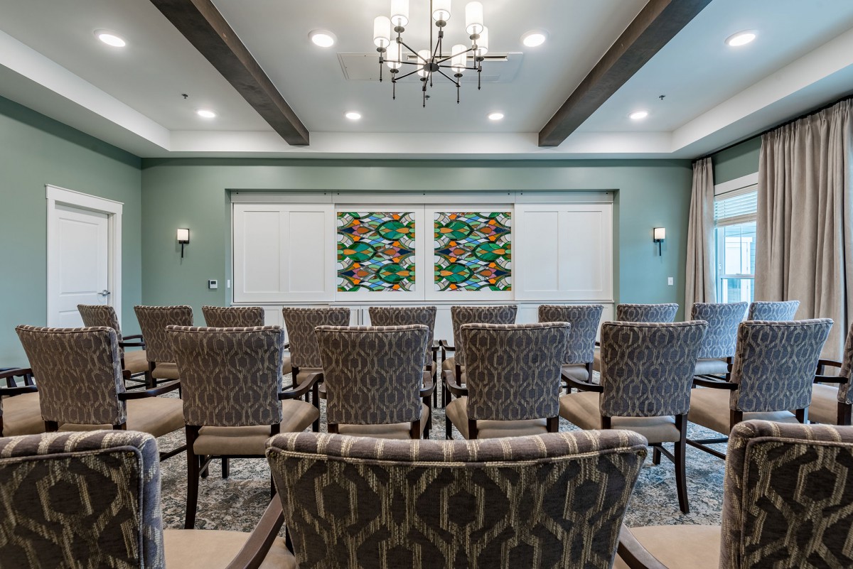 A well-arranged conference room with patterned chairs and elegant lighting.
