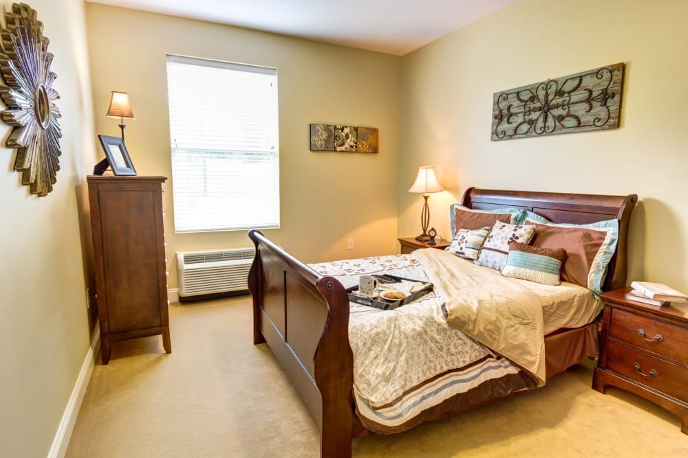 A cozy and well-lit bedroom featuring elegant furniture and warm decor.