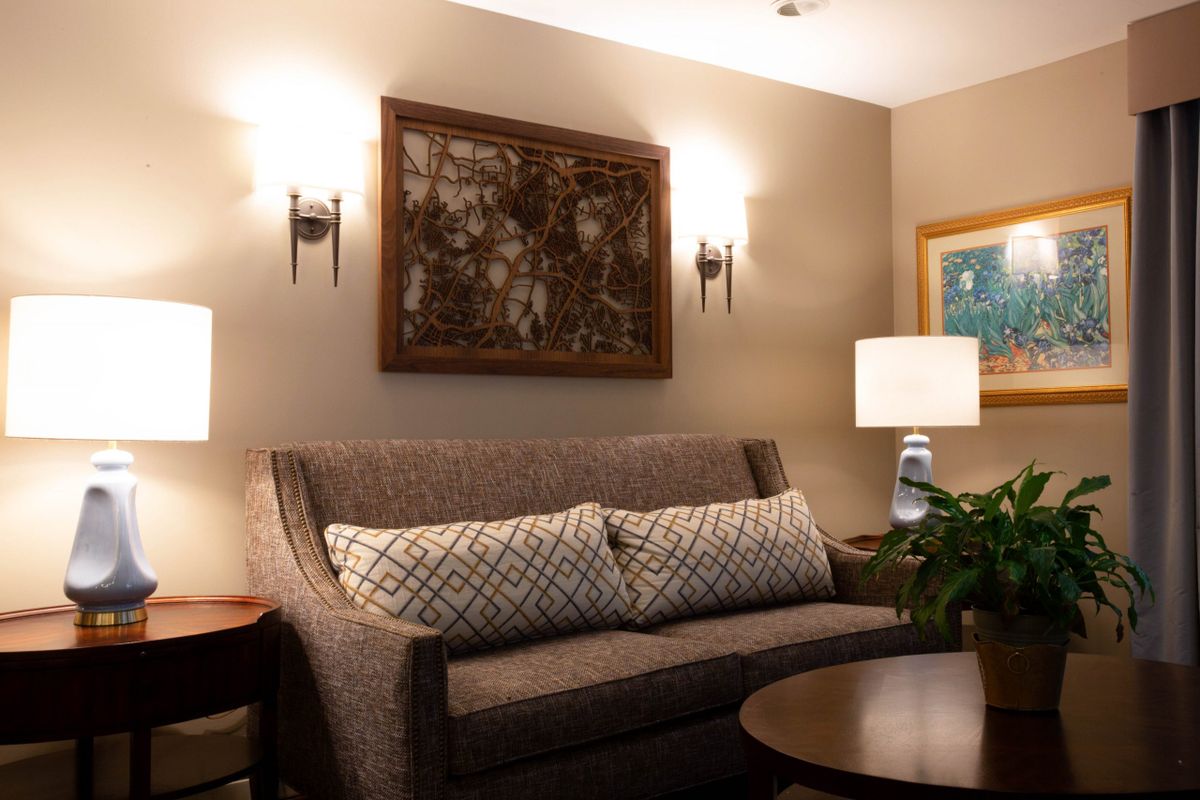 A cozy living room with a stylish sofa and decorative wall art.