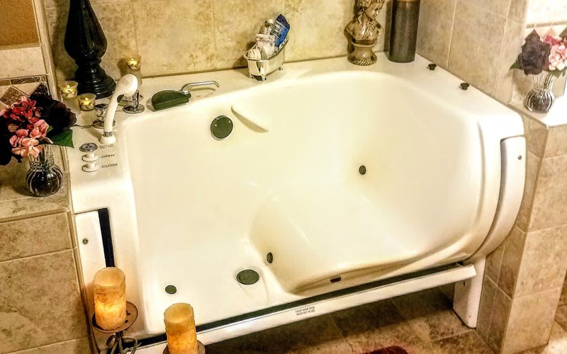 A spacious bathtub in a well-appointed bathroom.