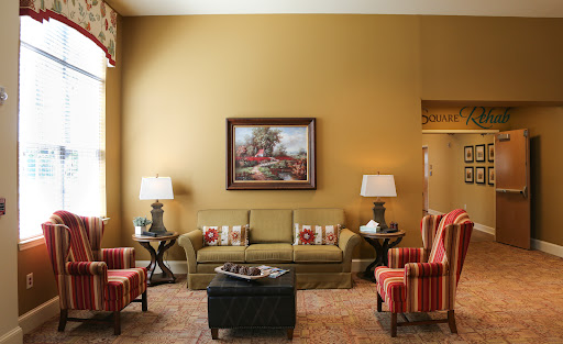 A cozy living room featuring warm colors, stylish furniture, and decorative elements.