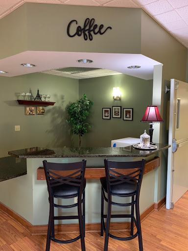 A cozy waiting area featuring a coffee station and modern decor.